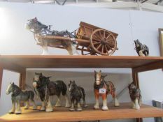 A collection of ceramic shire horses including one pulling dray