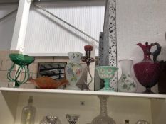 A shelf of interesting glass ware etc