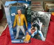 A Freddie Mercury doll and Queen calendar