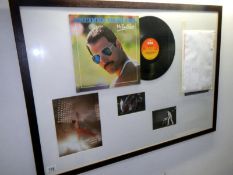 A framed & glazed Queen collage featuring a signed copy of Freddie Mercury,