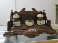 A wooden desk stand complete with porcelain inkwells and brush wipe (inkwells a/f)