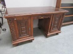 A carved oak double pedestal desk