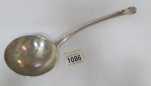 A heavy silver ladle