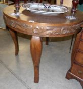 A circular carved oak table