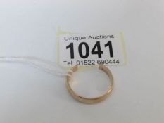 A 9ct gold wedding ring that has been cut off