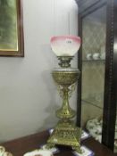 An ornate brass oil lamp