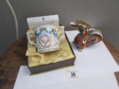 A Royal Crown Derby birth of Prince William loving cup and a silver button oriental dragon paper