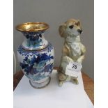 A Capo-di-monte ceramic dachsund with fitting for light and an enamel vase