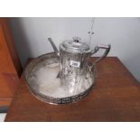 A silver plate teapot and tray