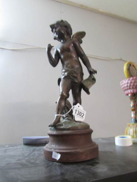 A bronze figure of a cherub