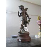 A bronze figure of a cherub