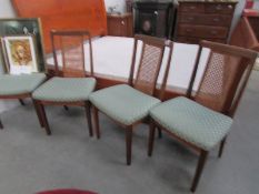 A set of 4 cane backed chairs