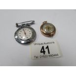 A nurses fob watch and one other