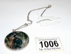 A vintage agate pendant set in silver and with attached chain
