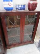 A mahogany glazed book case