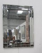 A bevelled wall mirror
