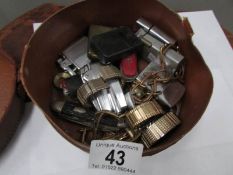 An old collar box with lighters, watches,