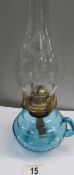 A blue glass hand oil lamp with chimney