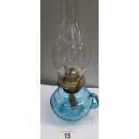 A blue glass hand oil lamp with chimney