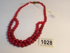 A red coral art deco necklace with 9ct gold clasp weighs 54gms