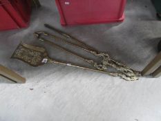 A set of ornate brass fire tools