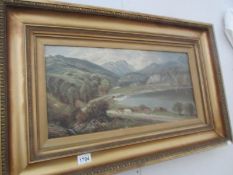 A gilt framed oil on canvas of cattle by lake,