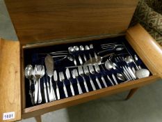 A carved cutlery table and cutlery
