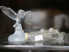 A glass bird and a bottle in the shape of a ship