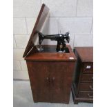 A Singer EE298498 electric sewing machine including mat and foot pedal, original accessories box,