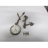 A silver pocket watch with silver graduated chain,