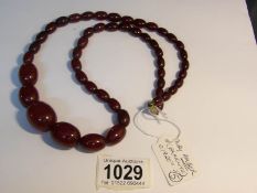 A ruby amber (bakelite?) or cornelian necklace