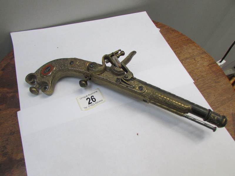 An ornamental flintlock pistol