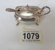 A silver mustard pot with blue liner and spoon by Mappin and Webb,