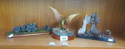 A model dragon and 2 models of war scenes