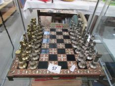 A metal chess set with board