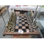 A metal chess set with board