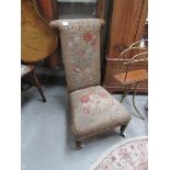 A 19th century prayer chair with tapestry seat and back