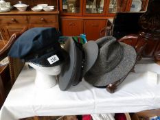 A quantity of military caps and other hats