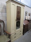 An antique painted pine wardrobe