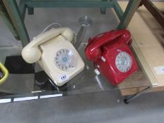 A cream and a red vintage telephones