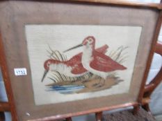 A framed and glazed tapestry of wading birds