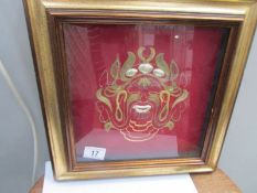 A framed and glazed gold thread embroidery