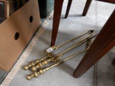 A set of brass fire irons