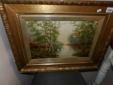 An oil on canvas 'Swans on pond'