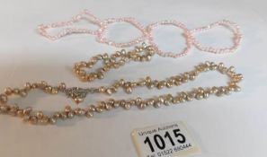 5 pearl bracelets and a pearl necklace