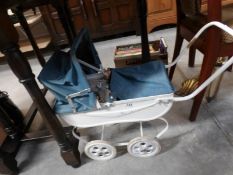 A vintage dolls pram and doll