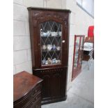 A good quality oak Priory style corner cabinet