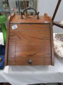 An oak coal box complete with shovel and liner