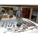 A good lot of metal and wood sword style letter openers and a knight figure