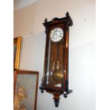 A mahogany twin weight Victorian Vienna wall clock